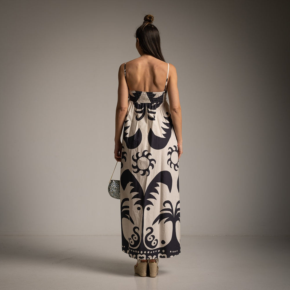 Back view of abstract black and beige maxi dress with smocked top and adjustable straps