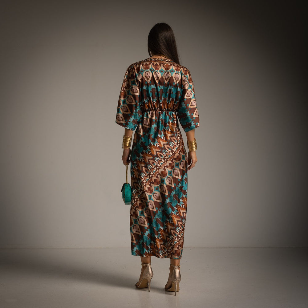 Back view of woman wearing Toscana kimono-style satin dress in a soft-lit studio