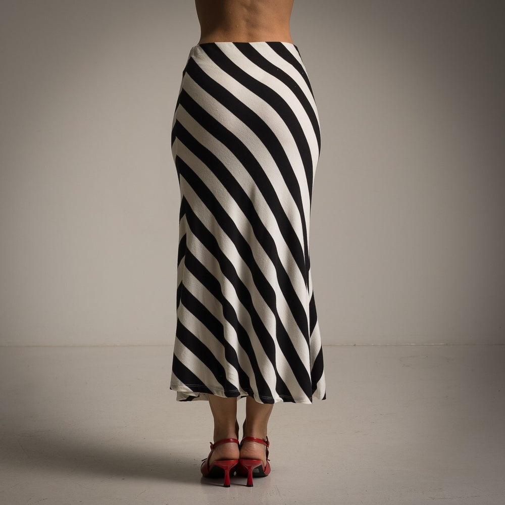 Back view of striped black midi skirt paired with red heels