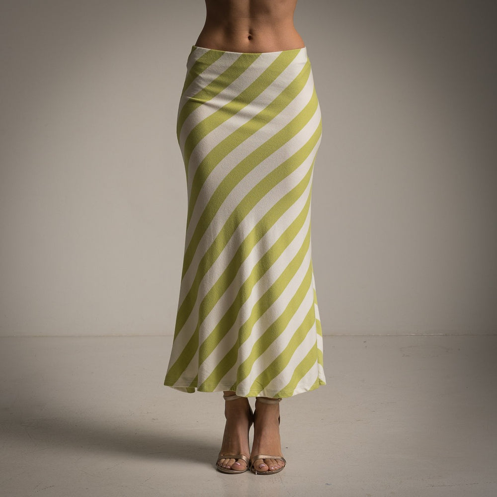 Front view of striped lime green midi skirt paired with neutral heels