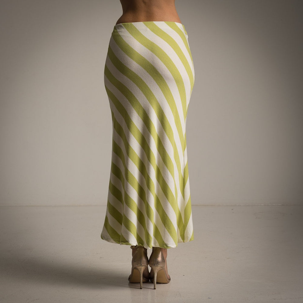 Back view of striped lime green midi skirt paired with neutral heels