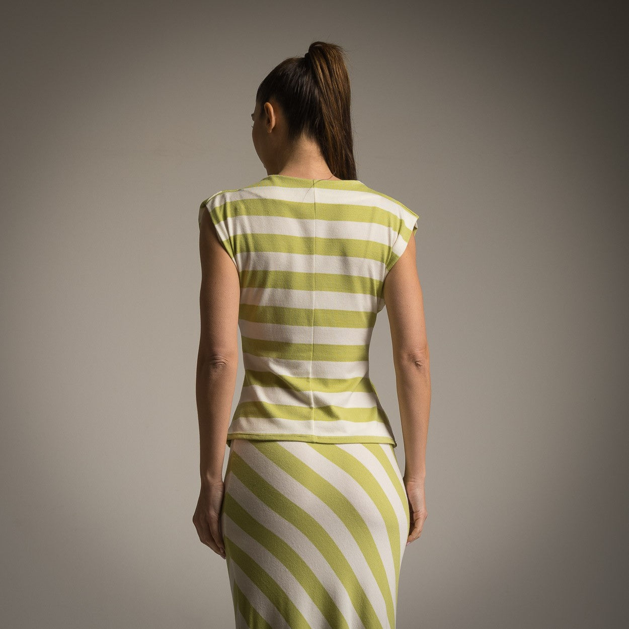 Back view of top and skirt set in lime green and white stripes with cap sleeves
