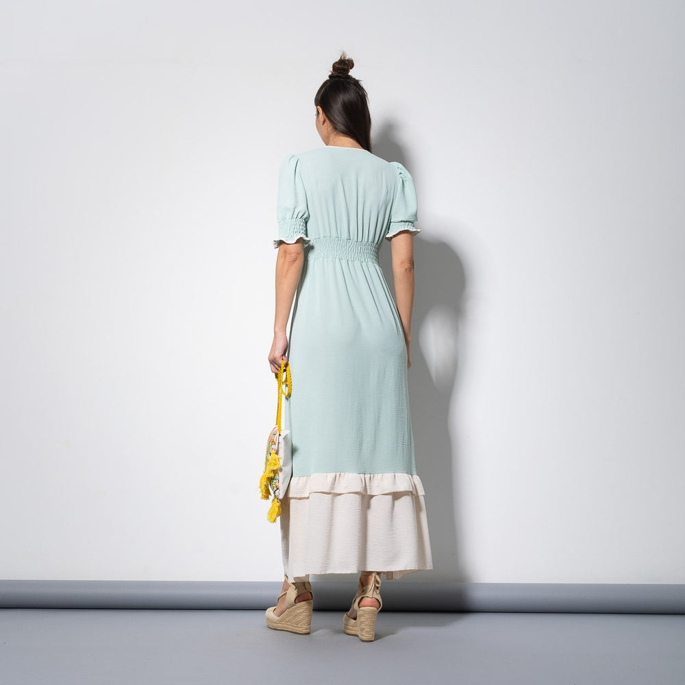 Studio shot of mint green and cream color block dress, back view with gathered waist