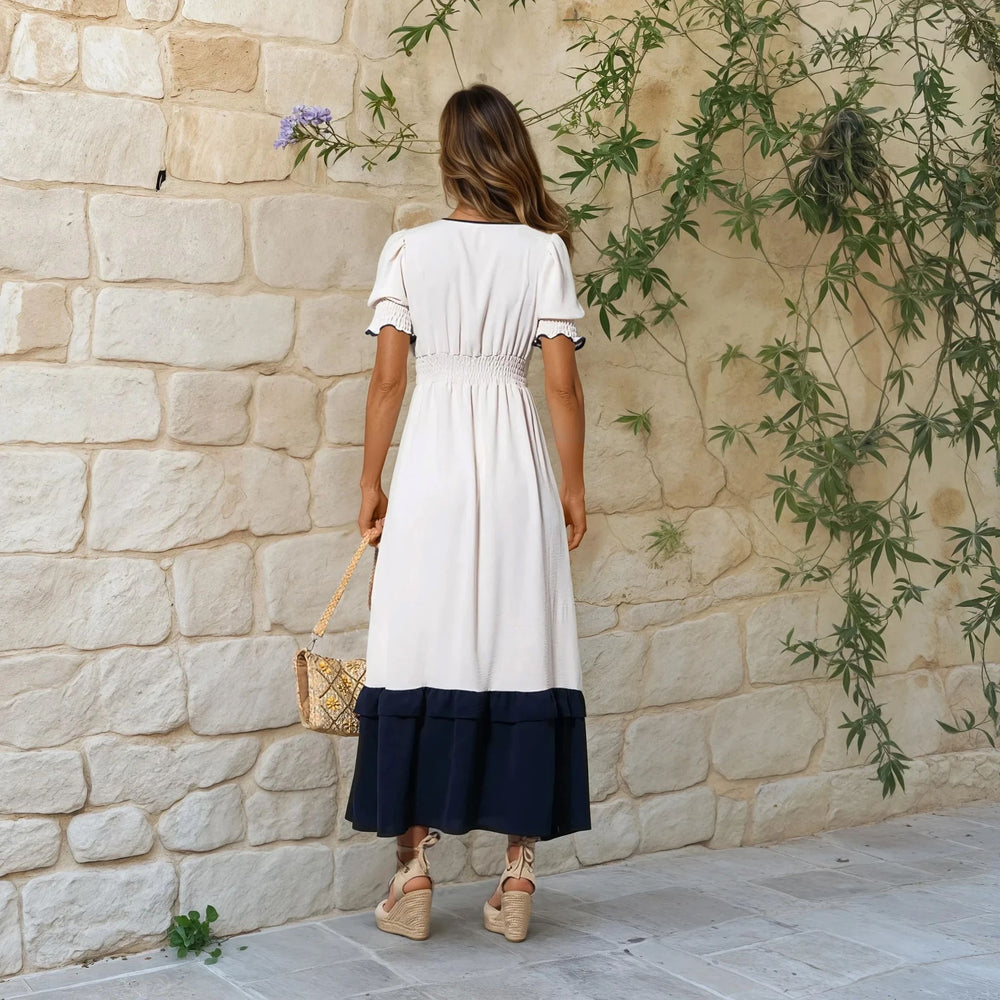 Back view of cream and navy contrast midi dress with elastic waist and wedge espadrilles