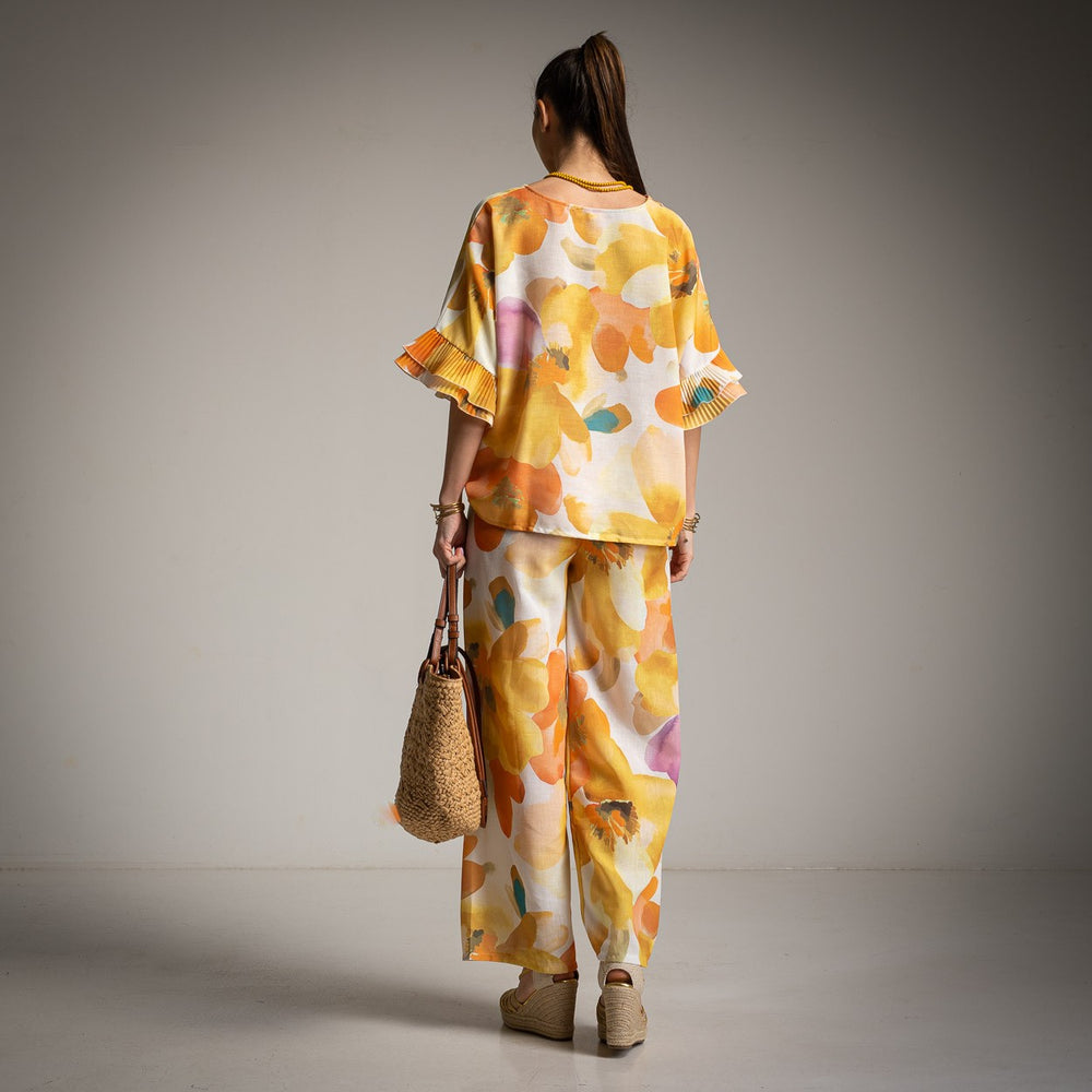 Back view of yellow floral set with loose blouse and flowy trousers