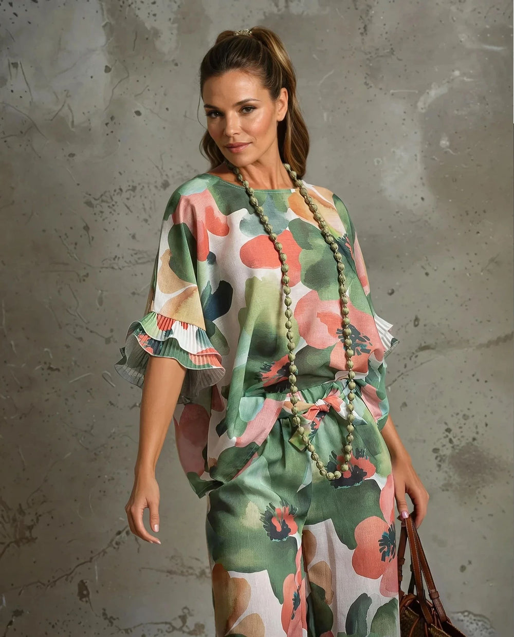 Close-up of green floral blouse with ruffled sleeves and elastic waist pants