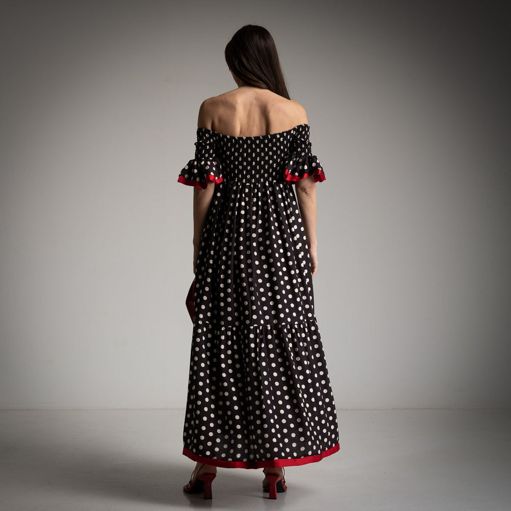Back view of the black and white polka dot summer dress in a studio location