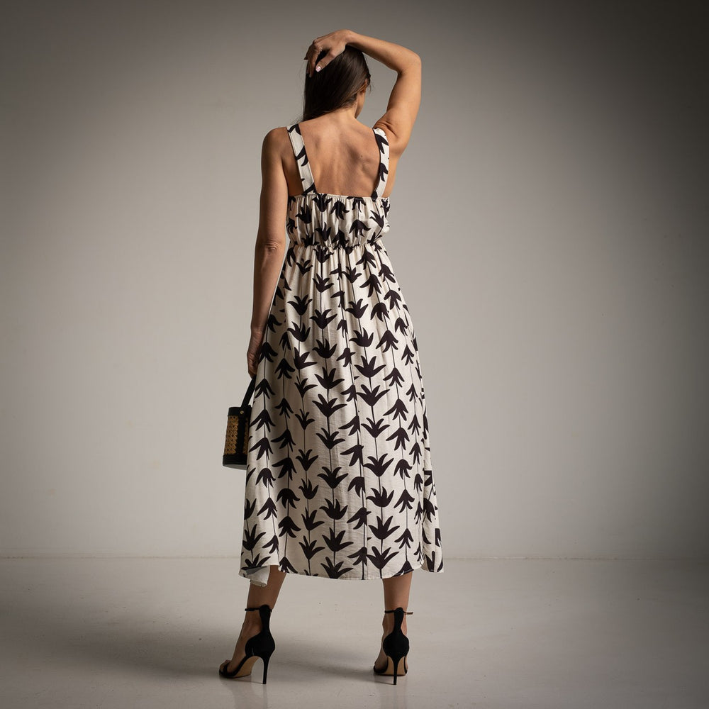 Back view of white leaf print midi dress showing ruched detail and flowy fit