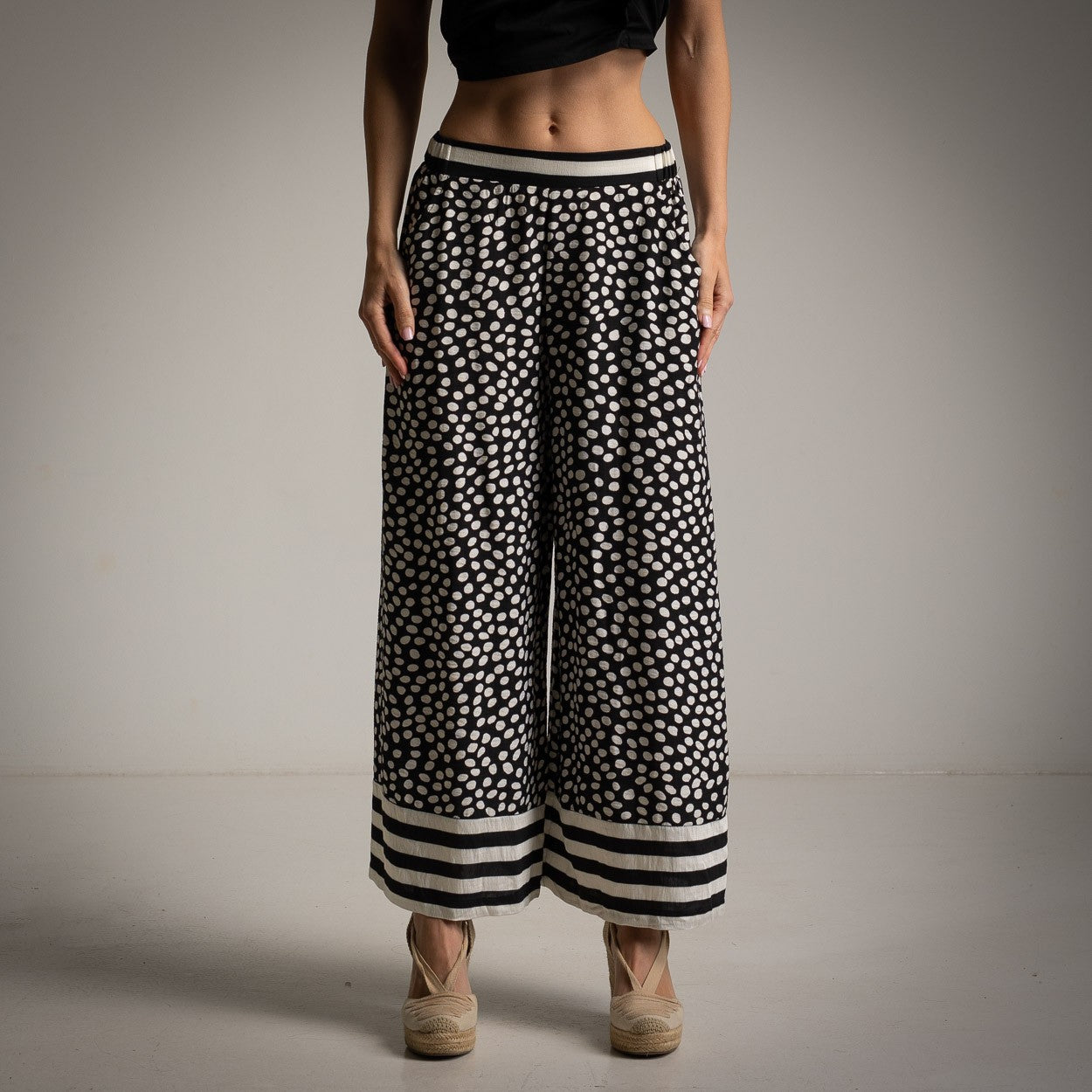 Front view of black culotte pants with polka dots and striped hem – lightweight summer fashion by MARIGIOÚ