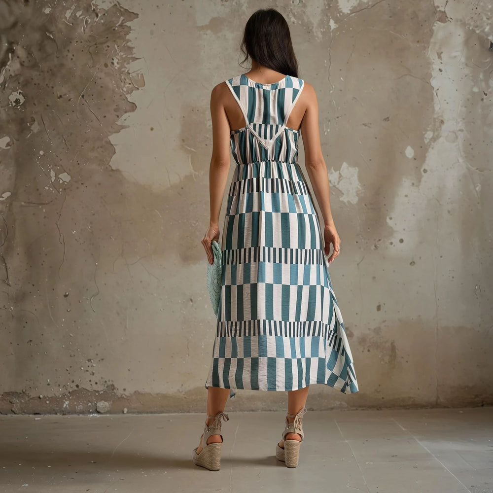 Back view of a blue and white graphic midi dress with crisscross straps and a smocked waistband – lightweight and feminine design for warm days.