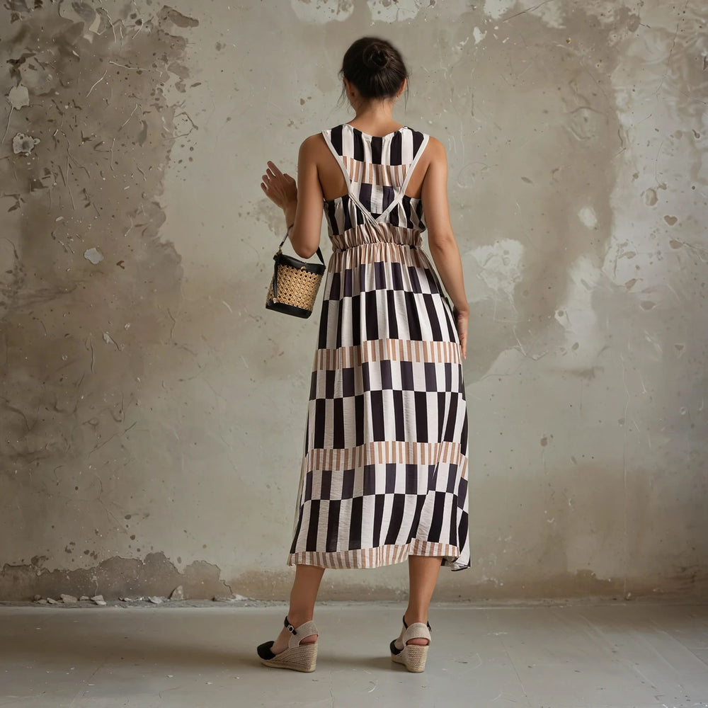 Back view of a sleeveless beige and black striped dress with an open back and gathered waist – effortlessly chic and perfect for sunny outings.