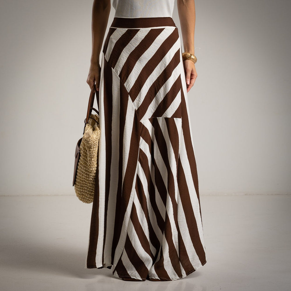 Front view of brown and white striped maxi skirt with asymmetrical panels and high waist