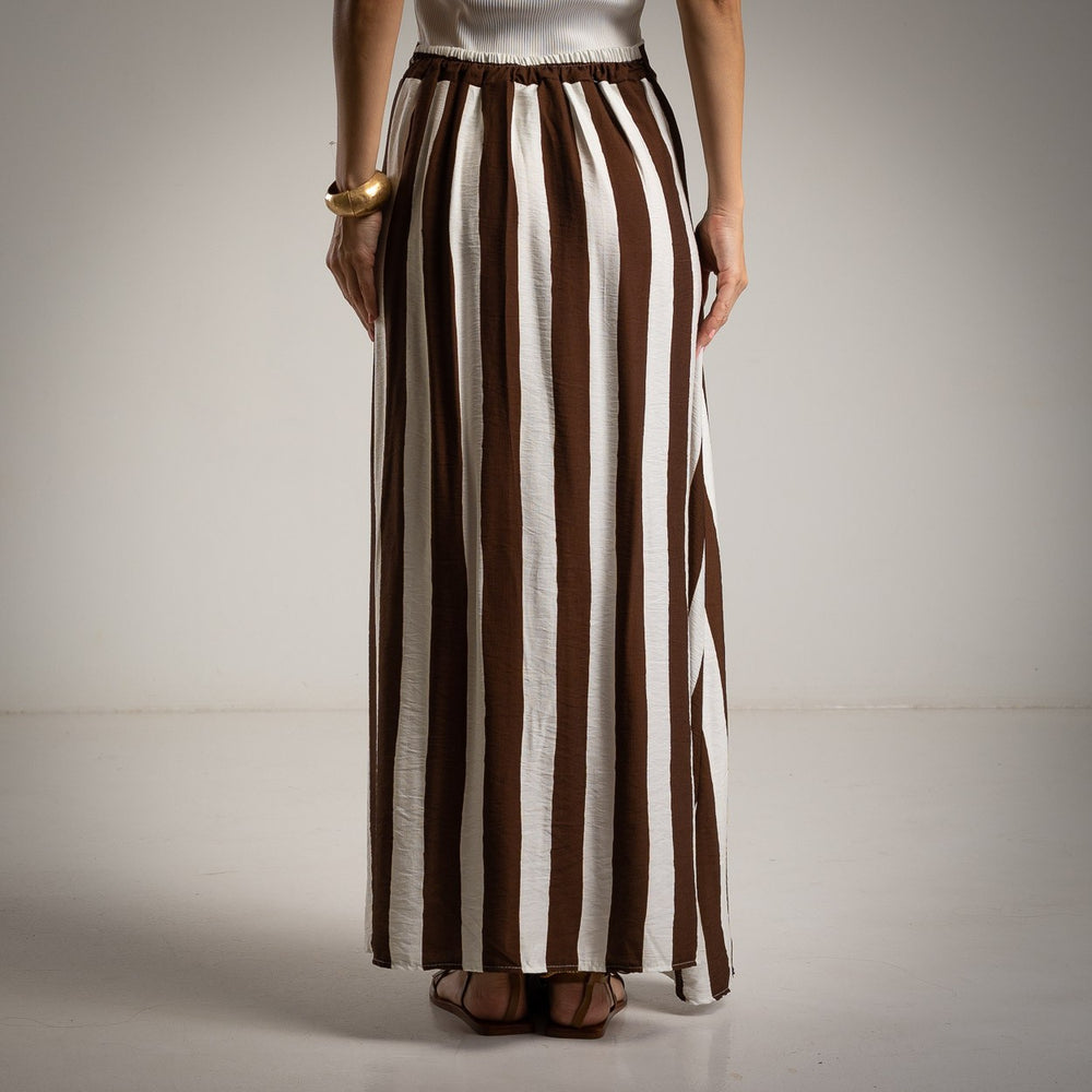 Back view of flowy brown striped maxi skirt with elastic waistband and vertical lines