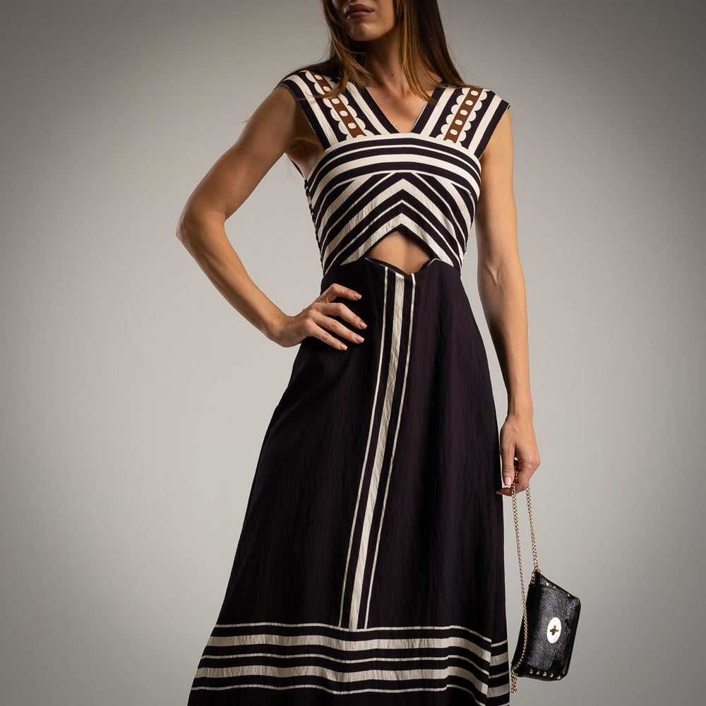 Close-up of black Italian midi dress with cream stripes and V neckline with cut-out under bust