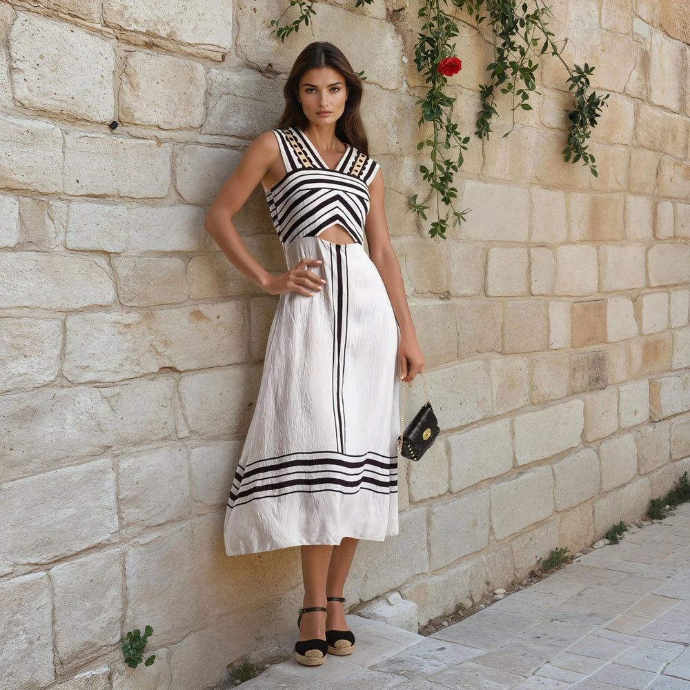 White midi dress with black geometric stripes and cut-out detail, styled for a summer look