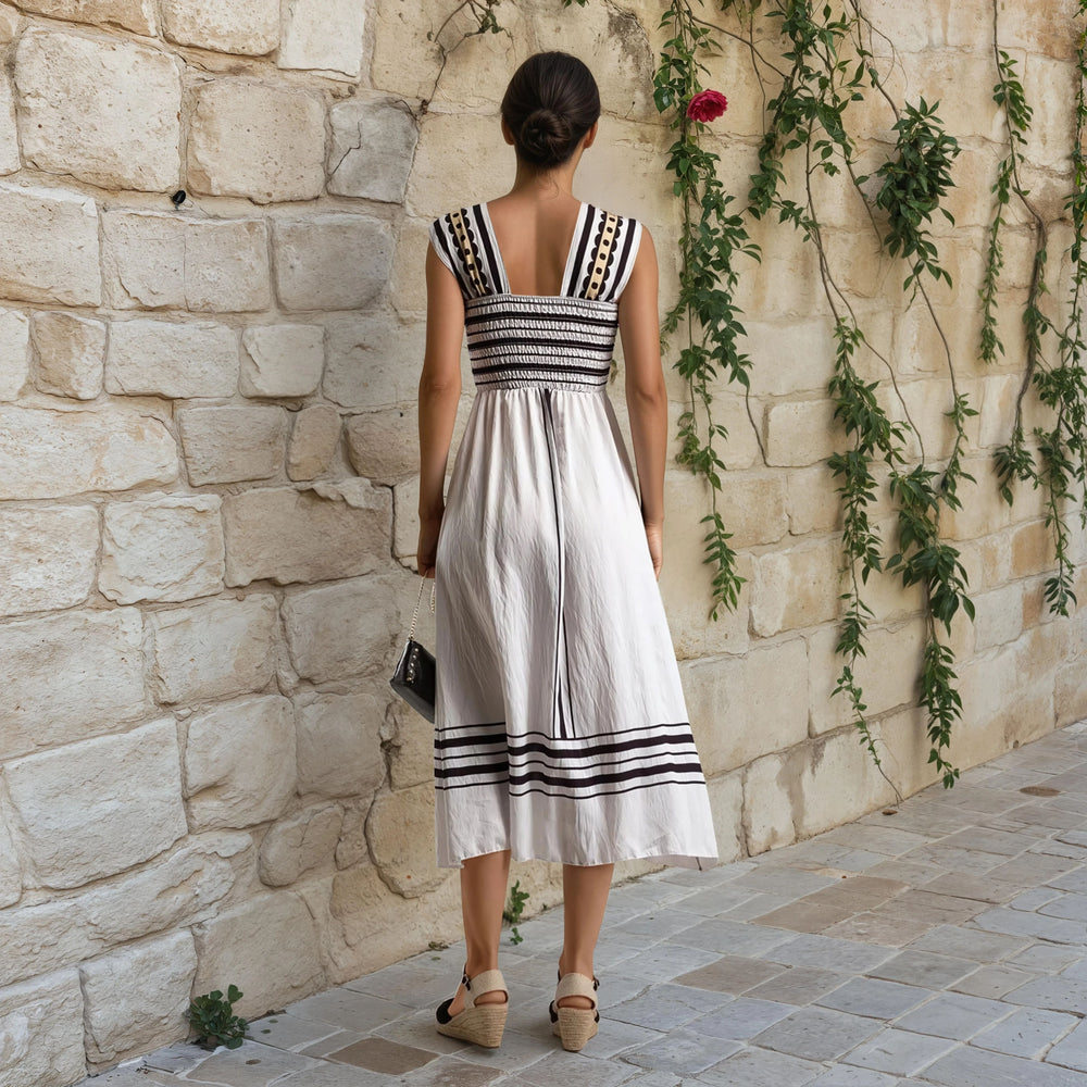 Back of white midi dress with elastic smocked waist and vertical stripe details