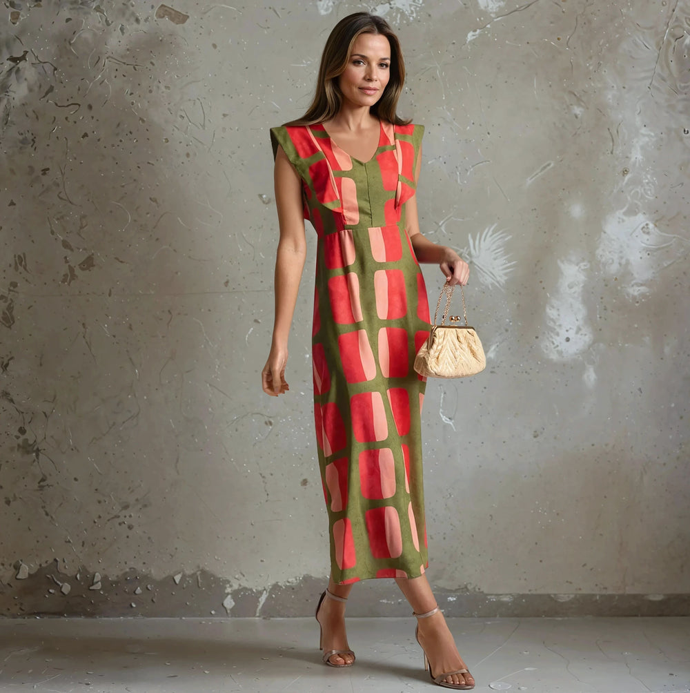 Full front view of the Retro Chic Geometric Midi Dress in olive green and pink retro print, paired with gold clutch – Autumn 2025 Collection.