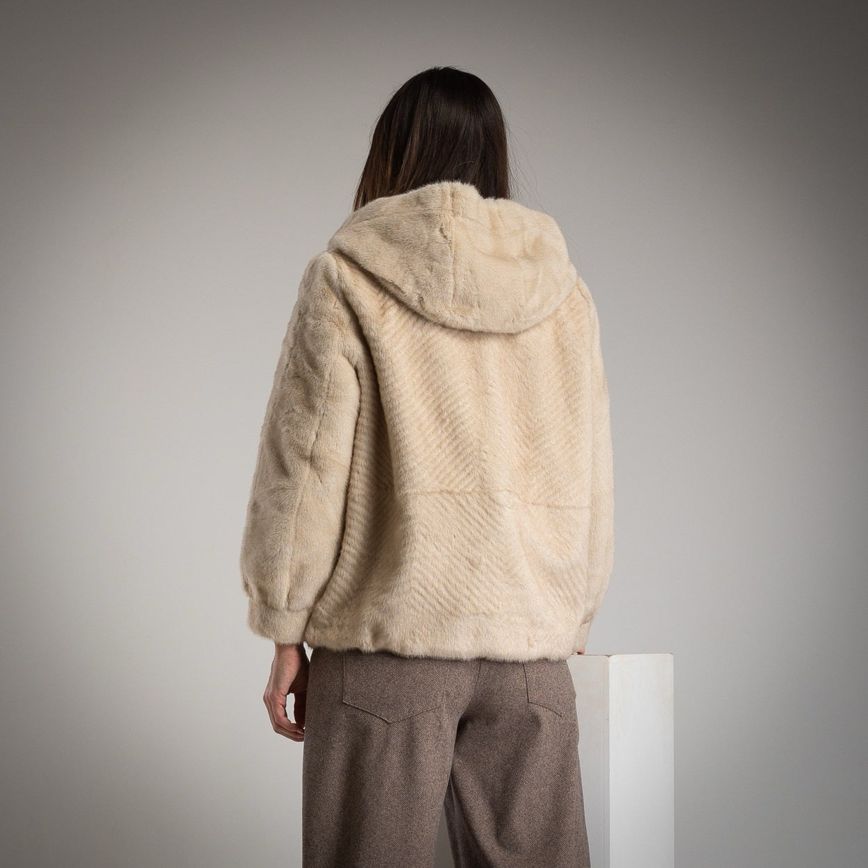 Back view of MARIΓIOÚ beige faux fur hooded jacket with relaxed silhouette and hood