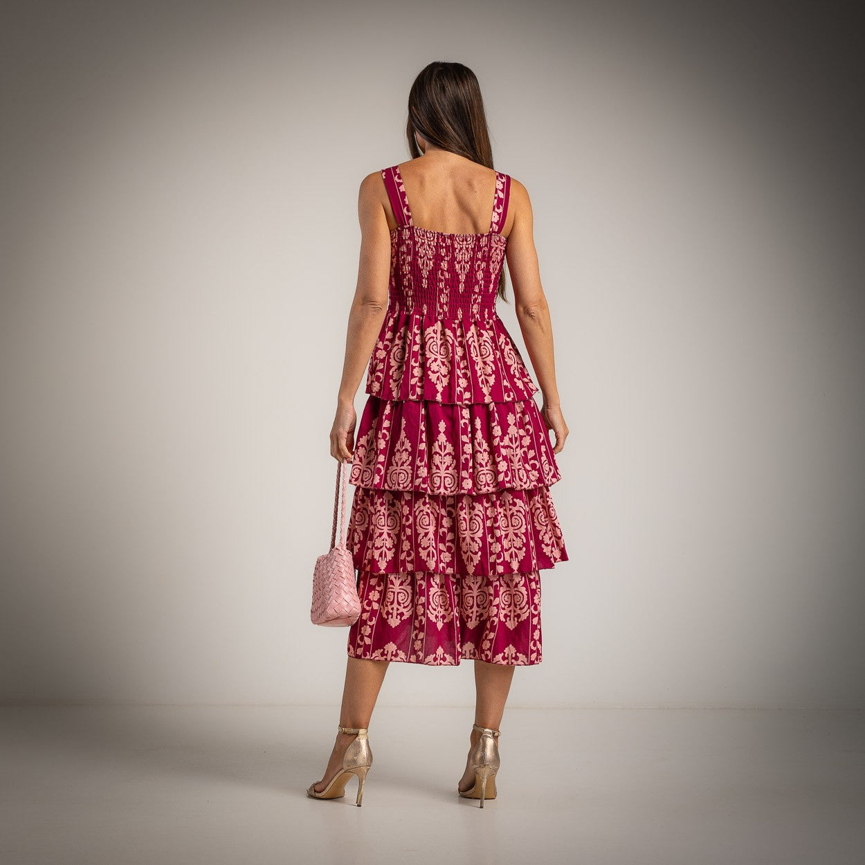 Floral tiered midi dress in bougainvillea pink and soft blush back view with layered skirt