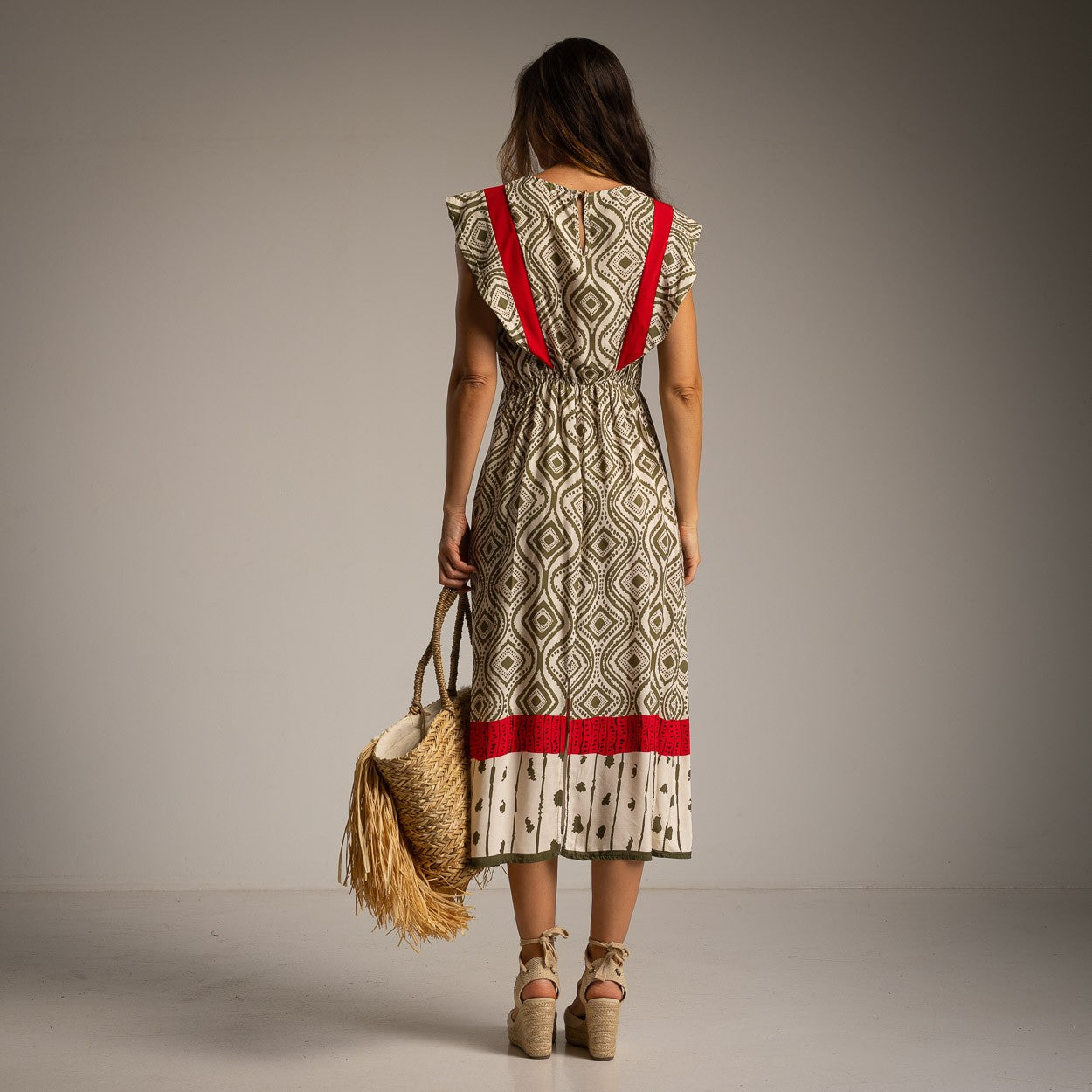 Back view of geometric print midi dress with scarlet red contrast details