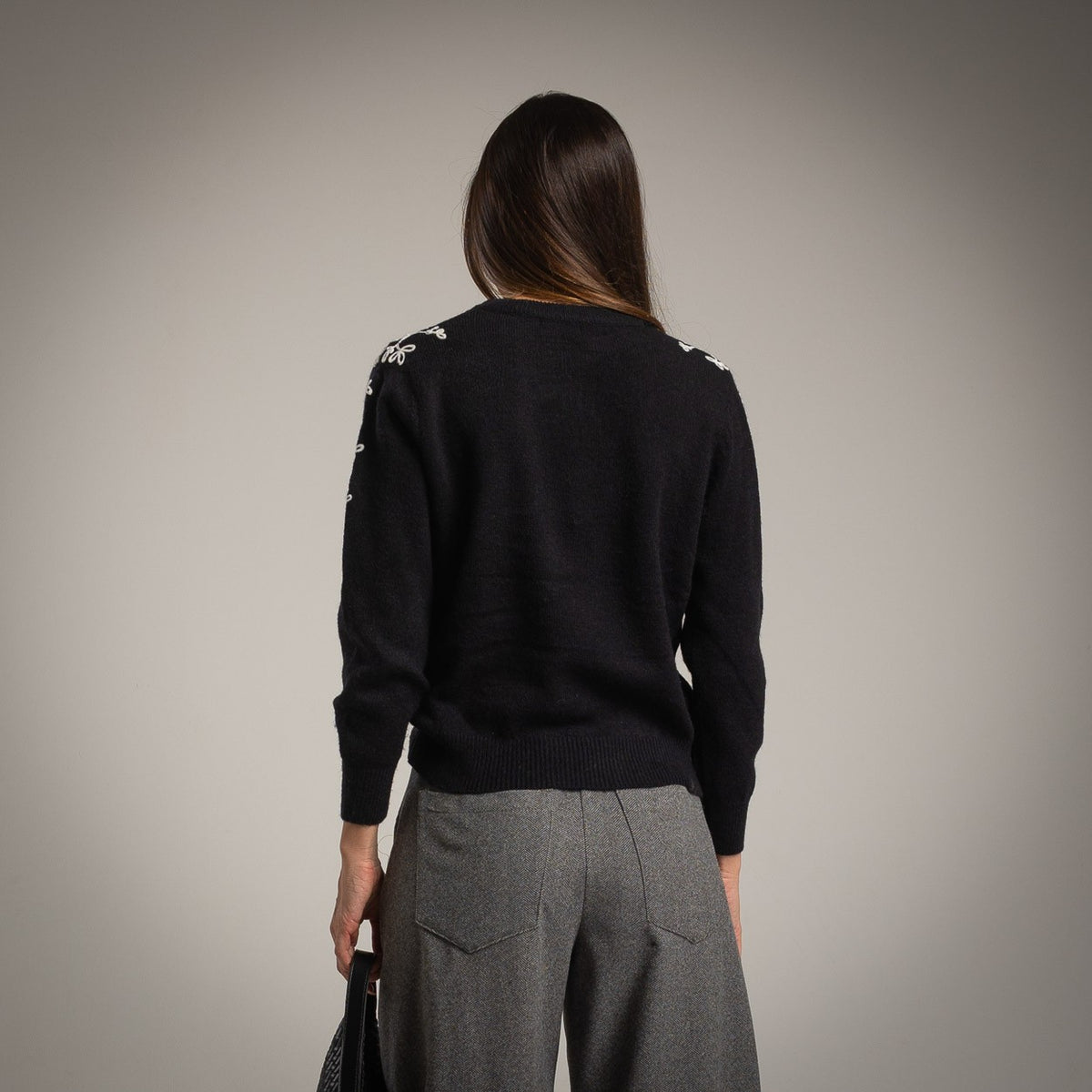 Black knit sweater with ivory floral shoulder embroidery - back view