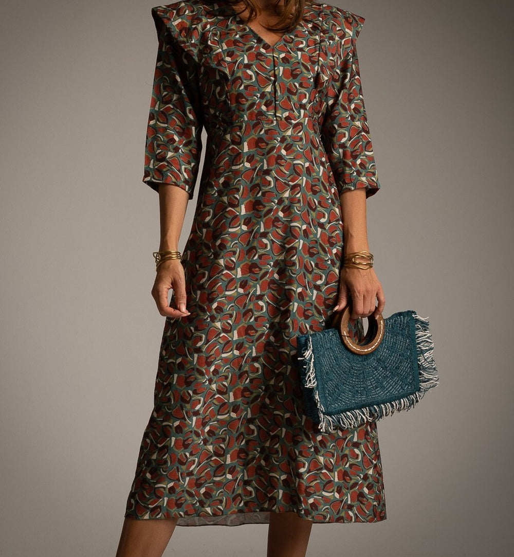 Close-up of MARIΓIOÚ midi dress with autumn leaves pattern and statement collar detail