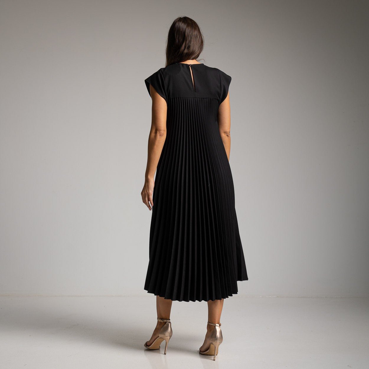 Black pleated midi dress with smooth yoke and cap sleeves - back view
