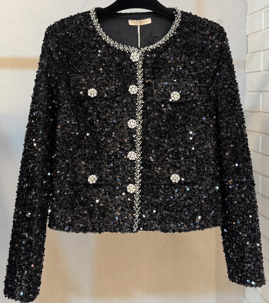 Front view of black embellished sequin jacket with sparkling crystal buttons and elegant trim.