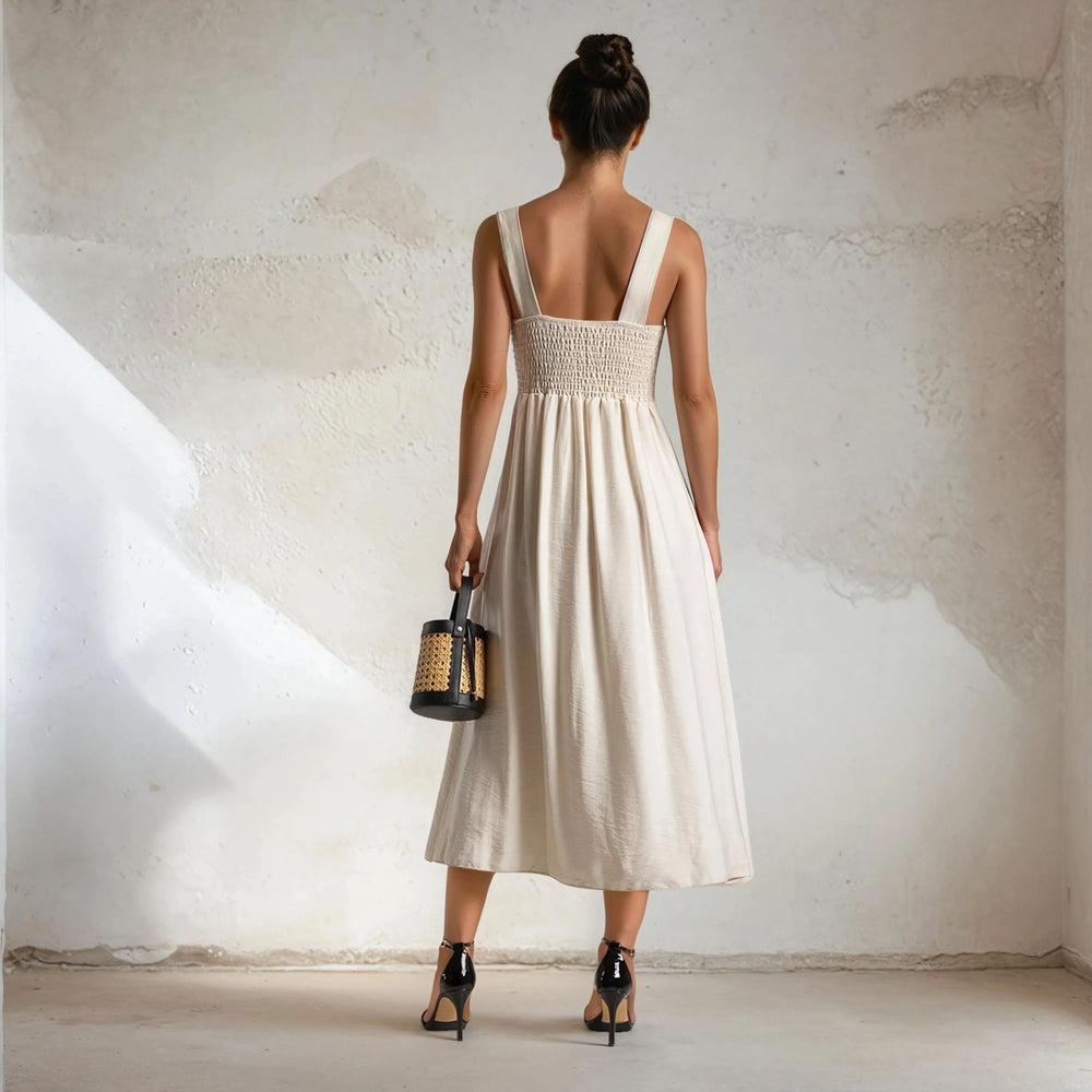 Back view of MARIΓIOÚ elegant off white midi dress with smocked panel and wide straps
