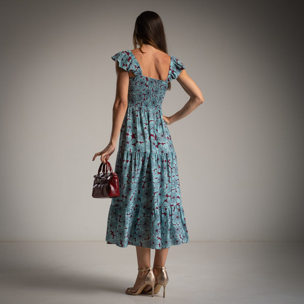 Back view of MARIΓIOÚ floral viscose midi dress in dusty blue with burgundy flowers – smocked fit and tiered skirt