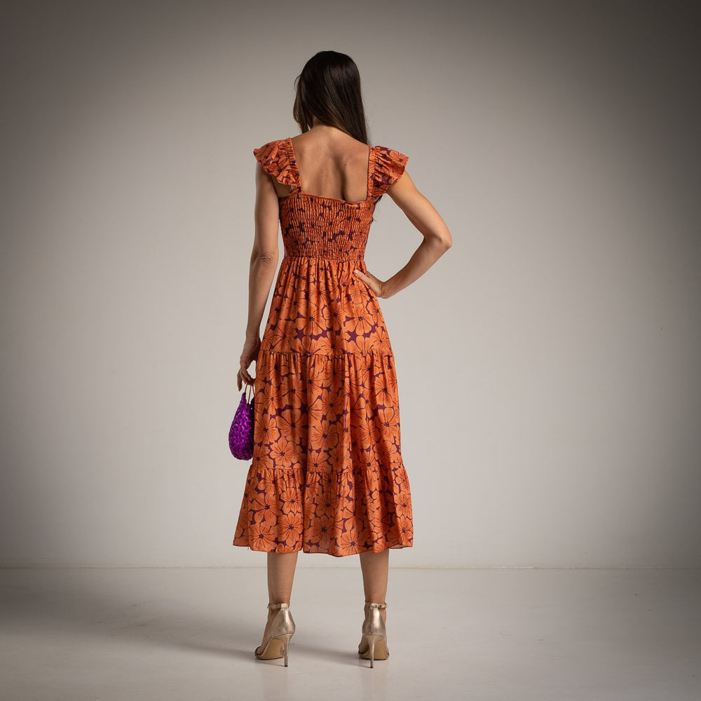 Back view of MARIΓIOÚ orange floral viscose midi dress with smocked back and flutter sleeves