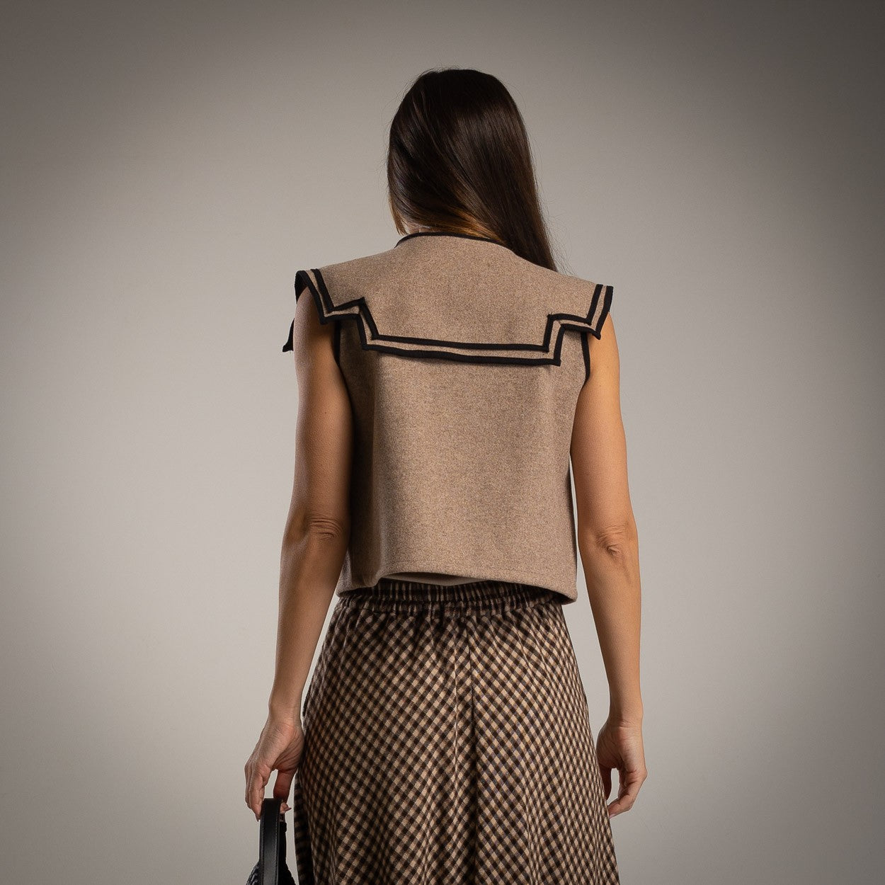 Back view of the Hazel wool vest in taupe with contrast trim