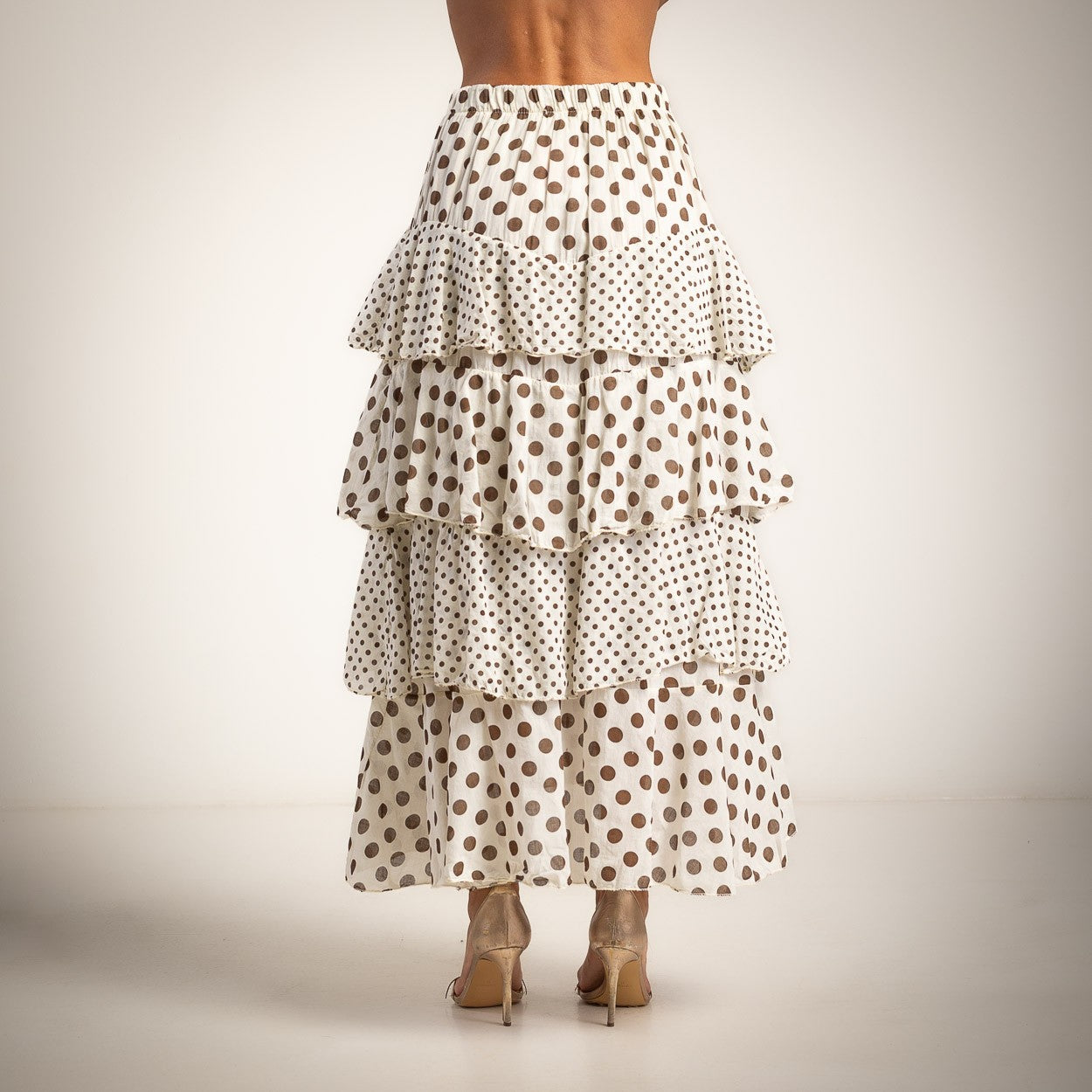 Back view of ivory white and chocolate polka dots layered maxi skirt with ruffle tiers