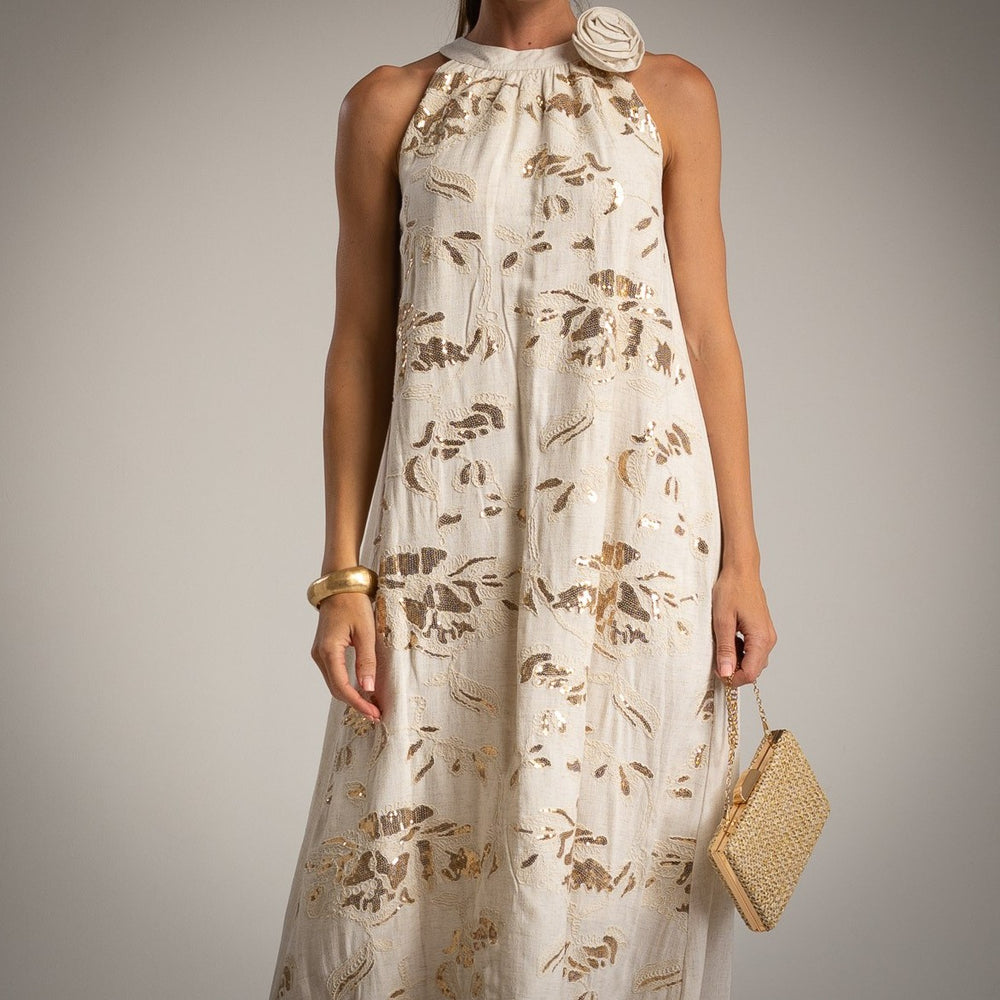 Close-up of halterneck dress with golden floral embroidery and flower detail – MARIΓIOÚ