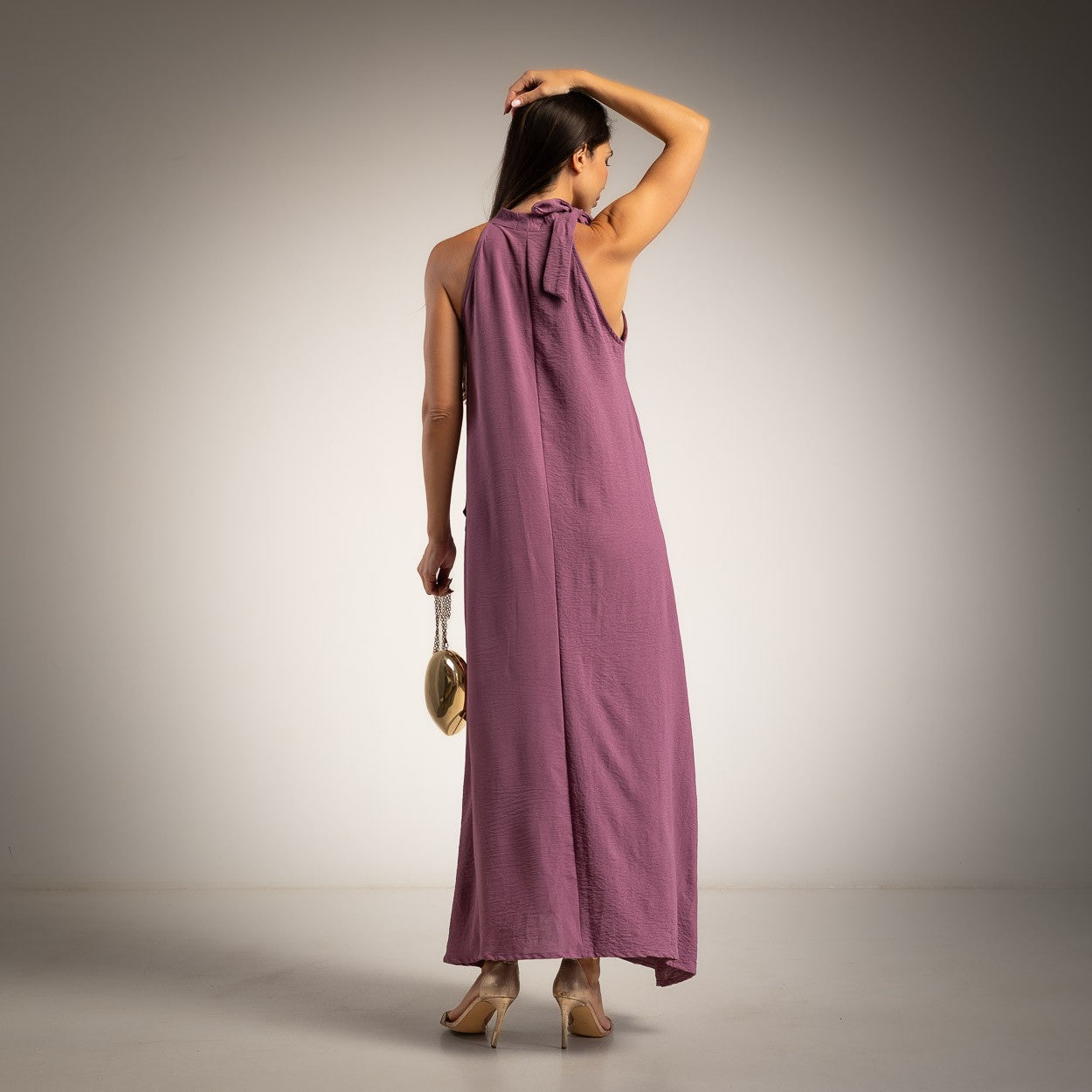 Back view of the Made in Italy Lavender halter maxi dress with bow neck detail