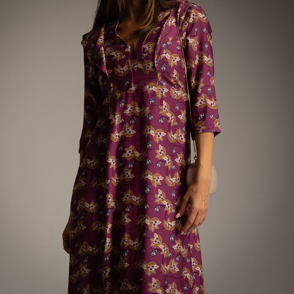 Close-up of MARIΓIOÚ magenta floral midi dress with collar detail and vintage-inspired shoulders