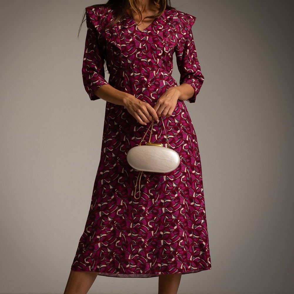 Close-up of Bugainvillea autumn floral midi dress with V-neck and statement shoulders