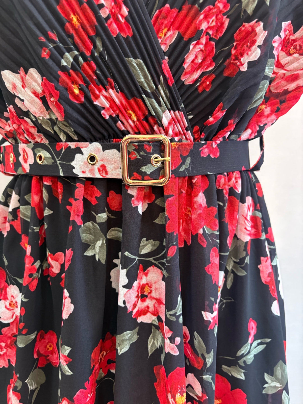 Close-up of pleated bodice and matching belt on midnight bloom floral midi dress