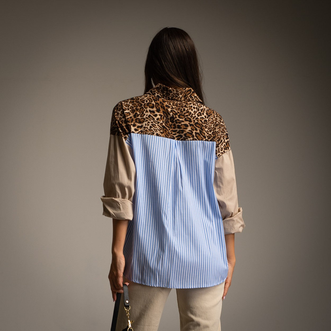 Back view of MARIΓIOÚ multipattern oversize blouse with blue stripes and leopard print panel