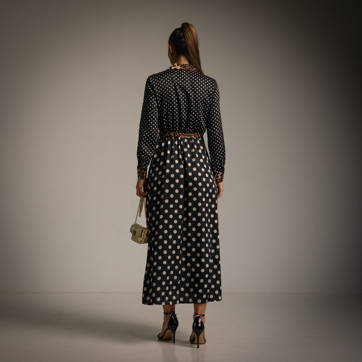 Black polka dot shirt dress with leopard print collar, cuffs and tie belt - back view
