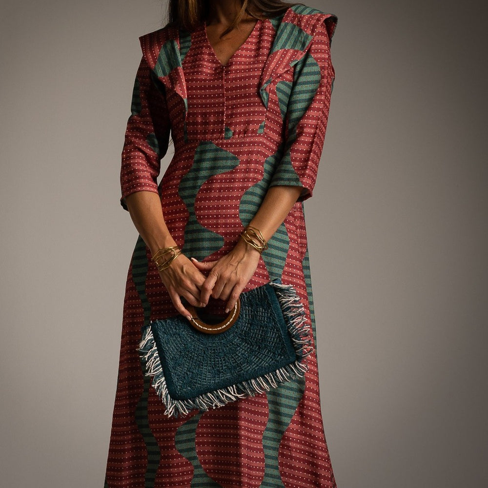 Close-up of retro geometric midi dress with V-neckline and ruffled shoulder detail