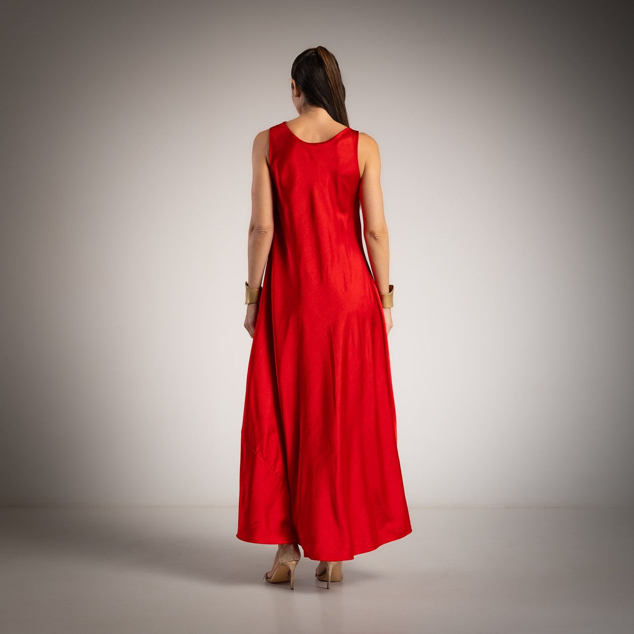 Back view of a scarlet red satin maxi dress with flowing silhouette