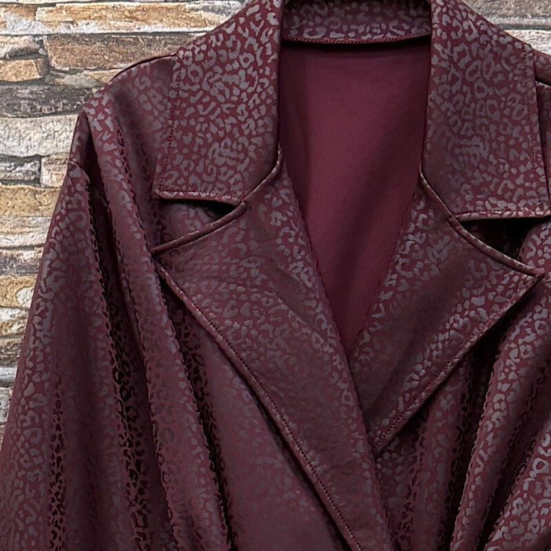 Deep Wine Red embossed leopard trench coat with wide lapels and tie belt - detail view
