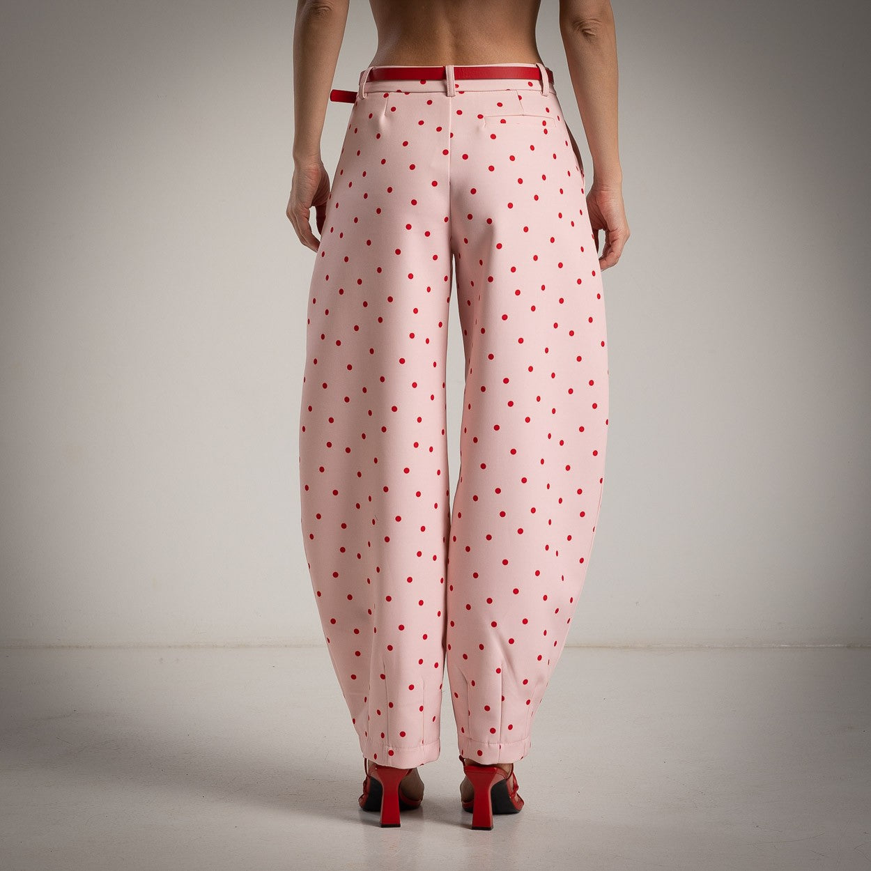 Back view of soft blush pink polka dots balloon pants with relaxed elegant fit