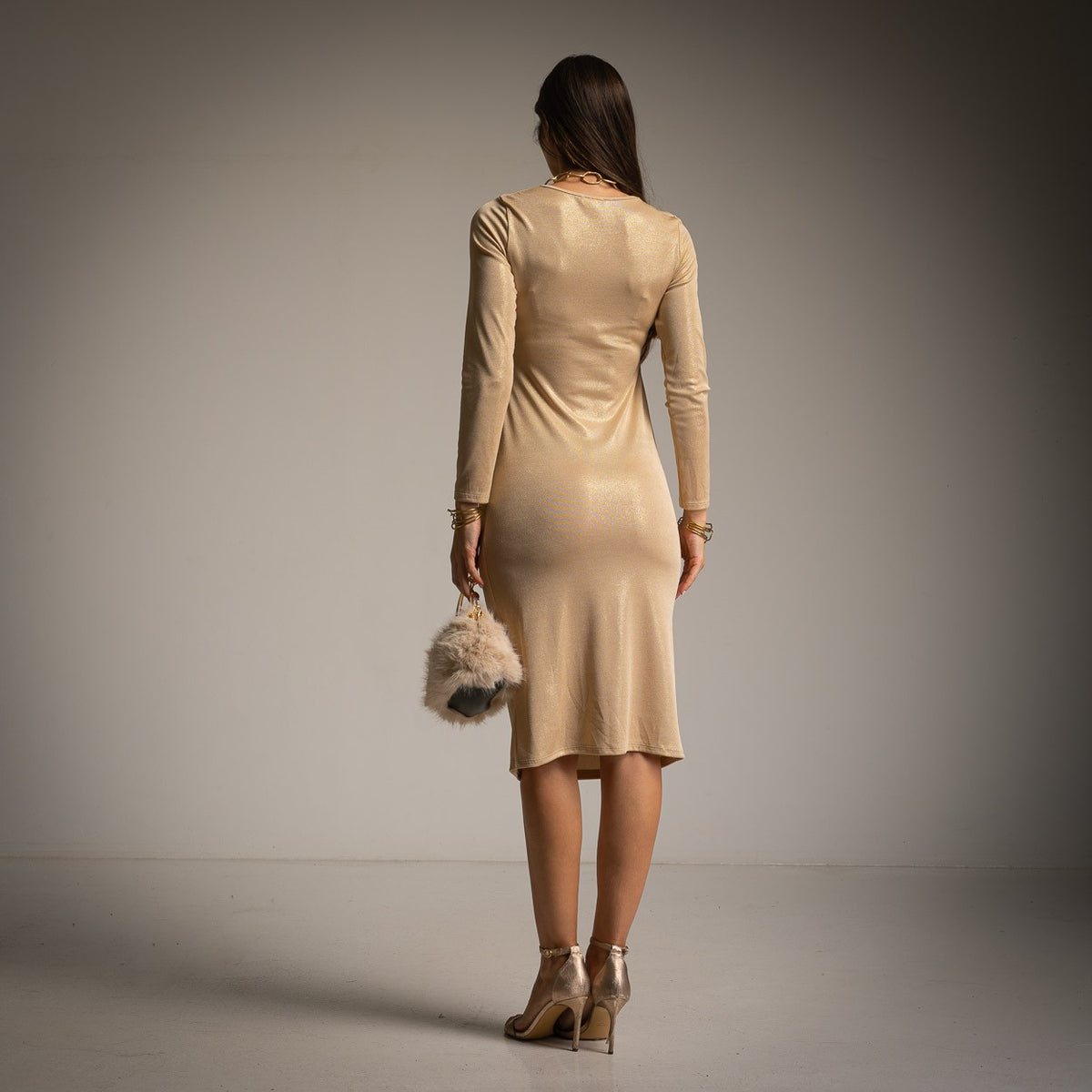 Champagne Gold shimmer midi dress with draped side tie and long sleeves - back view