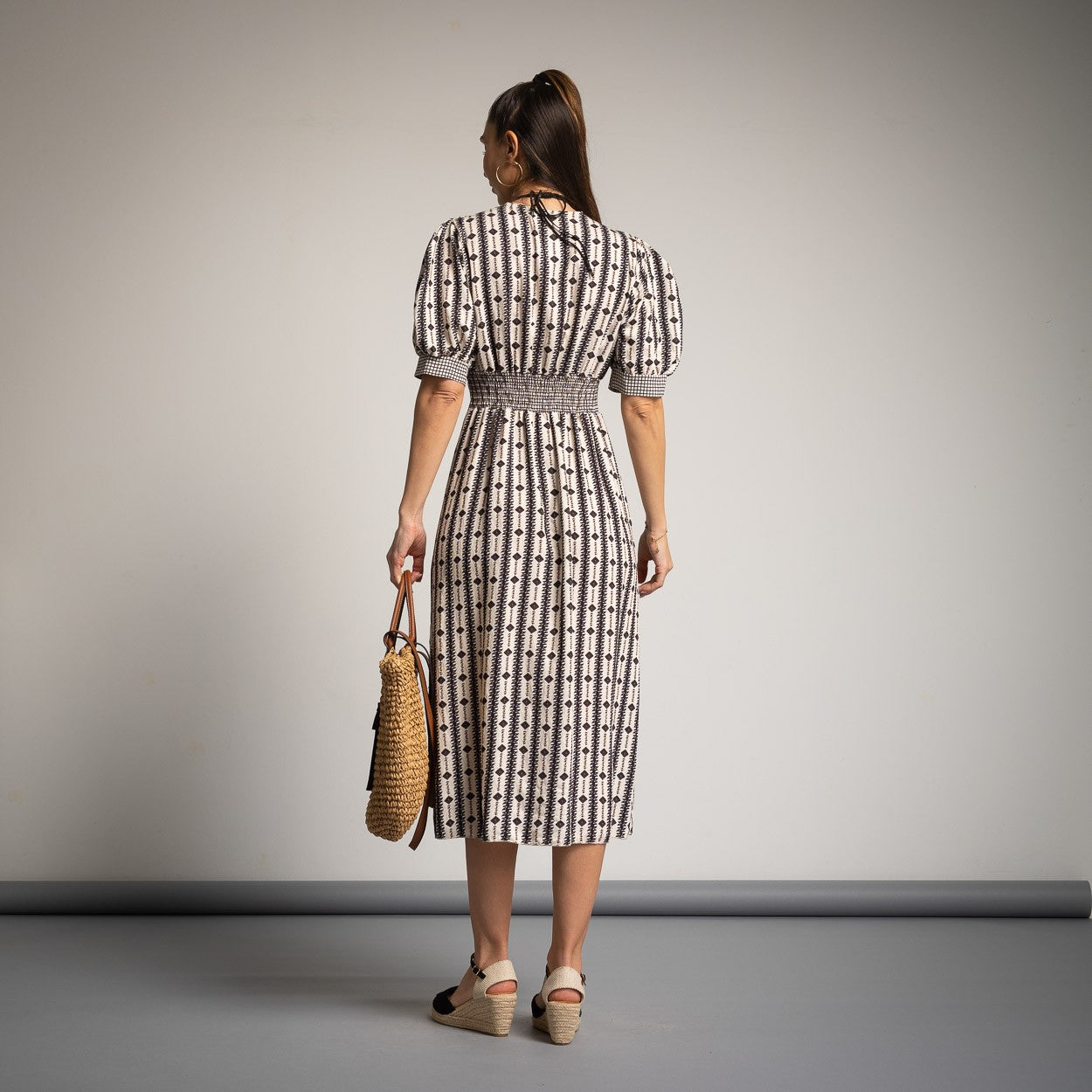 Back view of MARIΓIOÚ black spring midi dress with elastic waistband