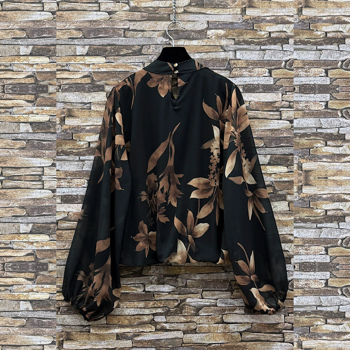 Black floral print blouse with sheer balloon sleeves and tie neckline - back view