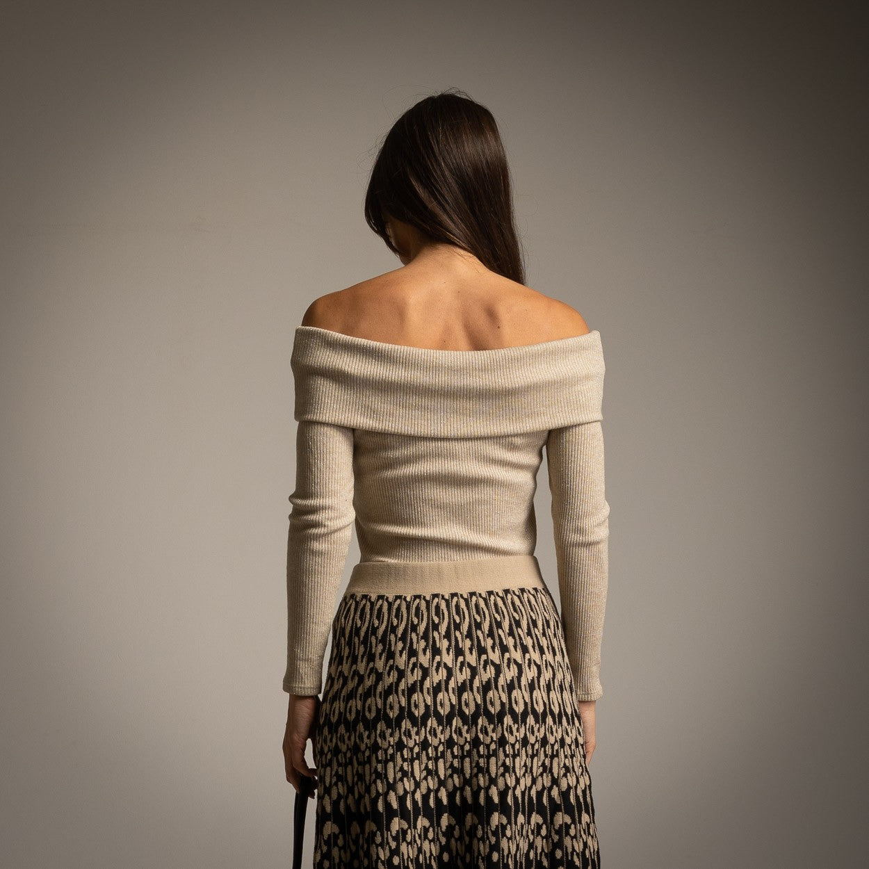 Back view of beige off-shoulder shimmer knit sweater