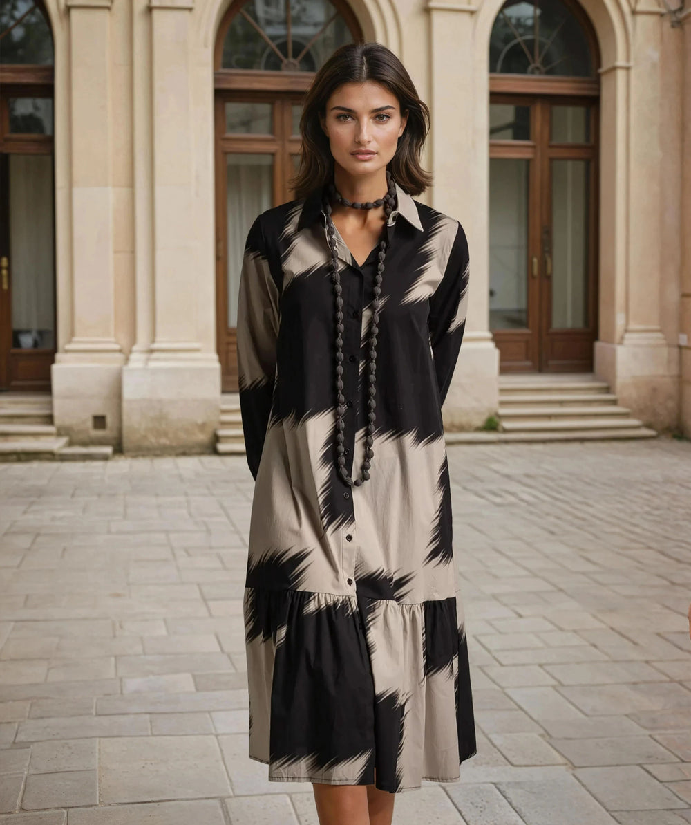 Model wearing oversize long sleeve midi dress with bold abstract print – close-up front view - Autumn 2025 Collection