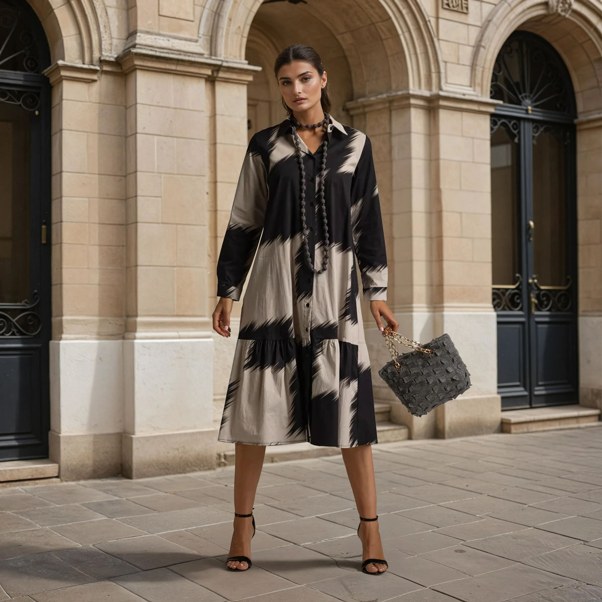 Full body front view of oversize patterned midi dress styled with handbag and heels - Autumn 2025 Collection